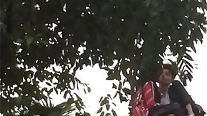 Young Indian couple’s intimate moment in a park