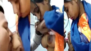 Office manager indulges in a steamy tit-sucking session with her employees