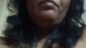 Desi mom with face sits before camera topless in solo sex clip