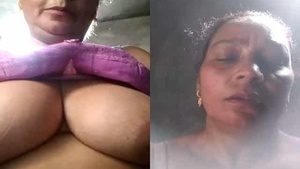 Mature woman flaunts her ample breasts on camera