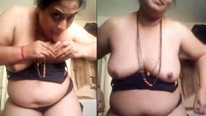 Mature woman indulges in self-pleasure with her own tits