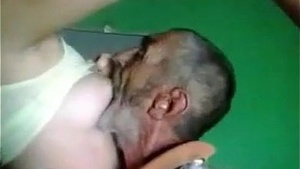 An old man sucking on a young blondes tits