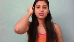 Beautiful Indian girl engages in masturbation with a dildo.