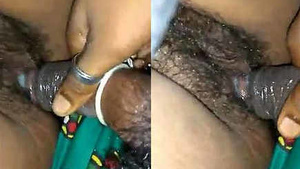 A middle-aged Indian sister at night happily fucked with a condom on her sister's hairy pussy