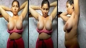 Big breasted hot Indian woman undresses in the bathroom