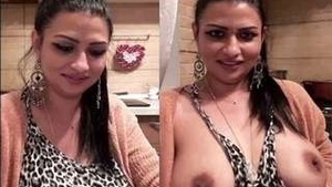 Beautiful NRI bhabhi shows her ample tits and masturbates while on a video call.