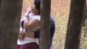 Young beauty gives a blowjob in a park; college lover is very daring.