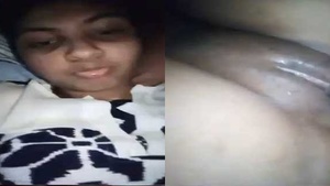 A hot village girl with small breasts fondles her hairy pussy.