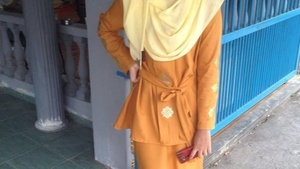 Young Indonesian woman in hijab pleasuring herself.