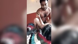 A bearded man makes love to a middle aged Indian house wife in the missionary position.