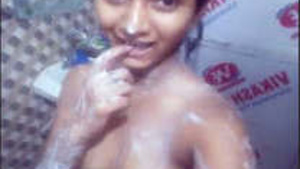Indian girl strips and sings while she masturbates.