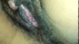 An Indian man pleases his wife by rubbing her hairy genitals.