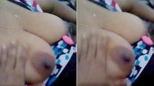A Sri Lankan housewife on a couch, her big boobs exposed and being fondled by a man.