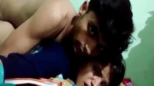 A passionate couple engaged in intimate moment on camera.