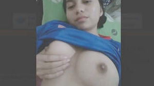 Beautiful girl with big bosom shows off her assets.