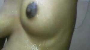 A Tamil woman undresses at home and washes up with her husband.