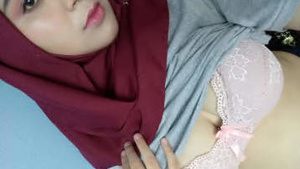 Part of a hot Indian girl in a hijab, some of the action with her breasts.
