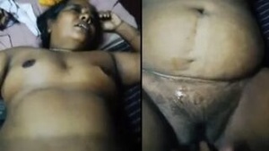 This is a MMS video of an older Indian woman wearing a blue dress as she pleases herself.