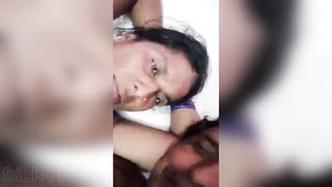 A rural Indian couple strips during a phone sex call.